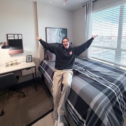 a person leaning on a bed in a bedroom